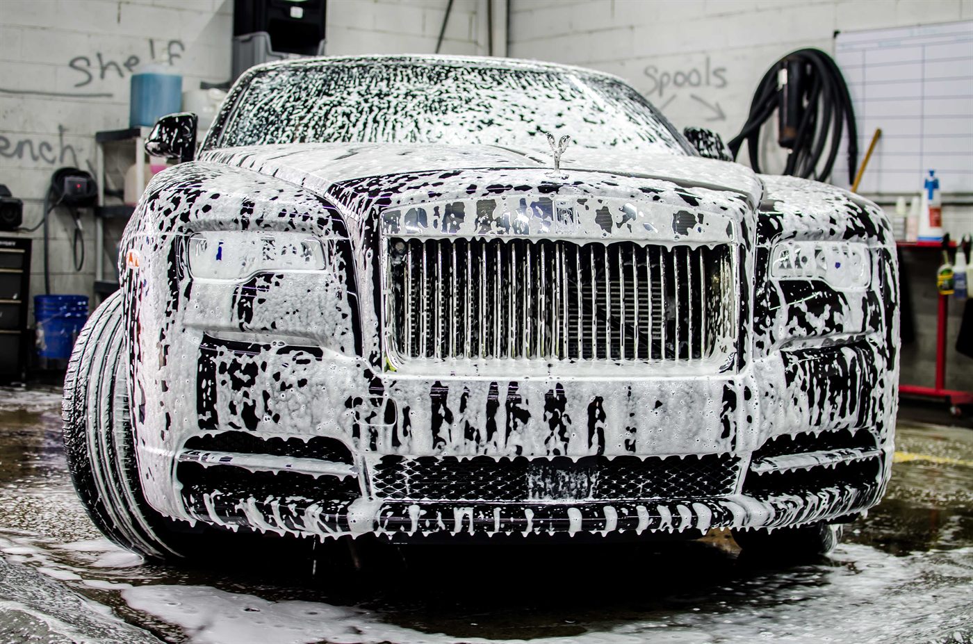 A foam-covered Rolls-Royce being washed